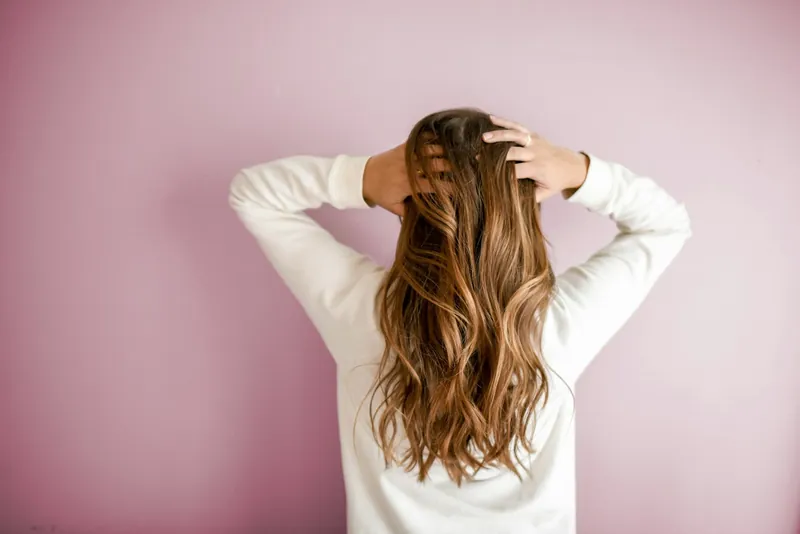 Long, glossy blonde hair moving in the breeze