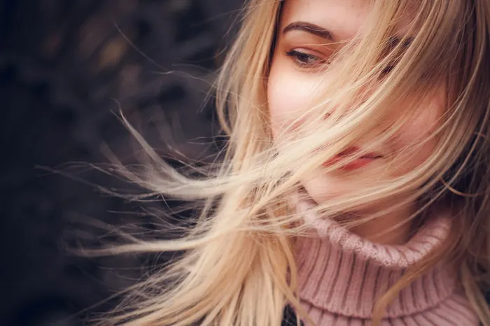 Long, glossy blonde hair moving in the breeze