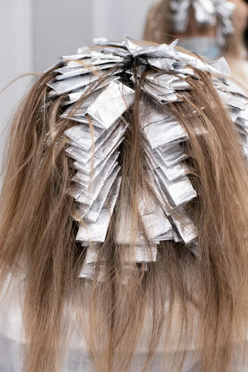 A stylist working on a client's hair