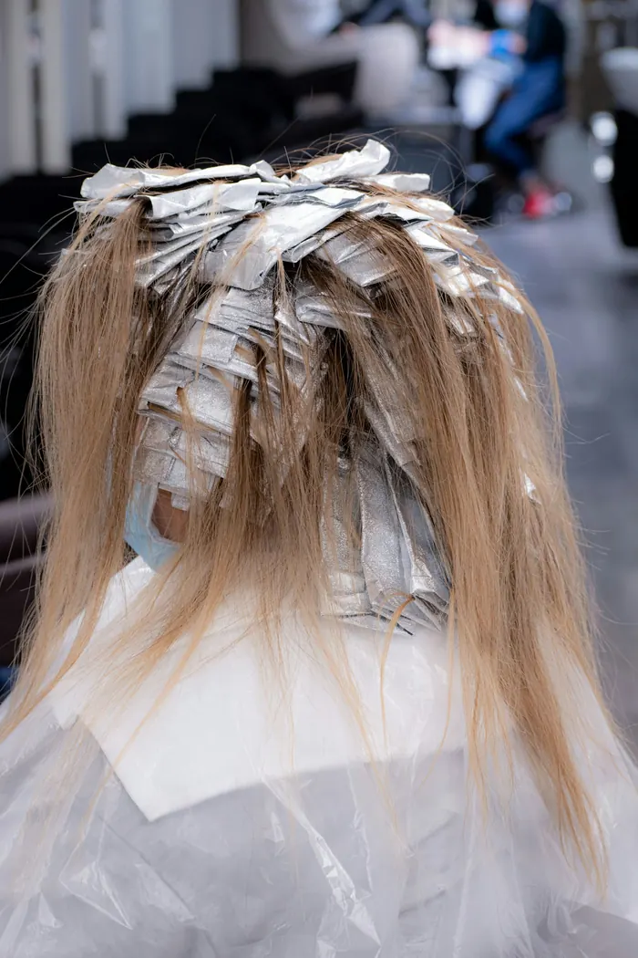 A stylist working on a client's hair