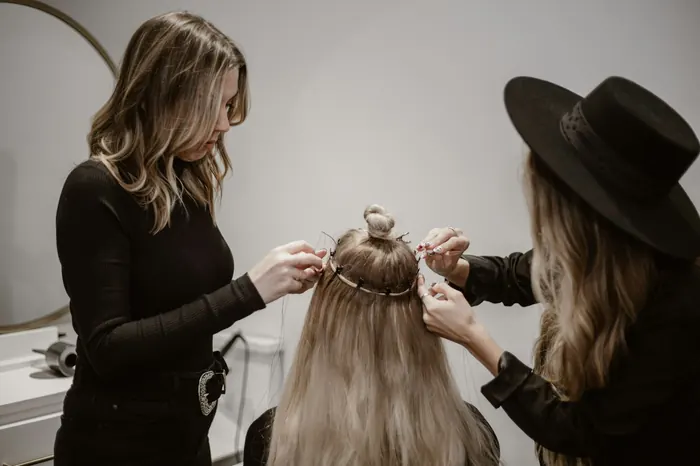 A client's hair being washed and treated at the basin
