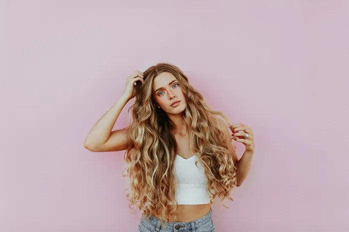 Woman with long, softly waved, sun-lit hair